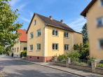 Straßenansicht - Freistehendes ZFH – bezugsfertiges OG + 43 m² Nutzfläche im DG, Garten + 2 Garagen